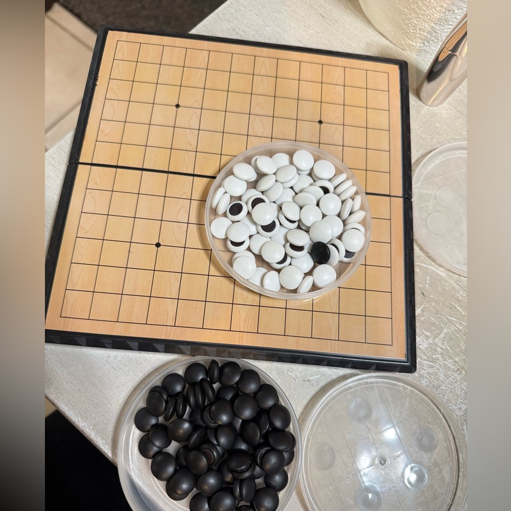 Classic Go Board Game Set with Black and White Stones
Five in a row. Gomoku